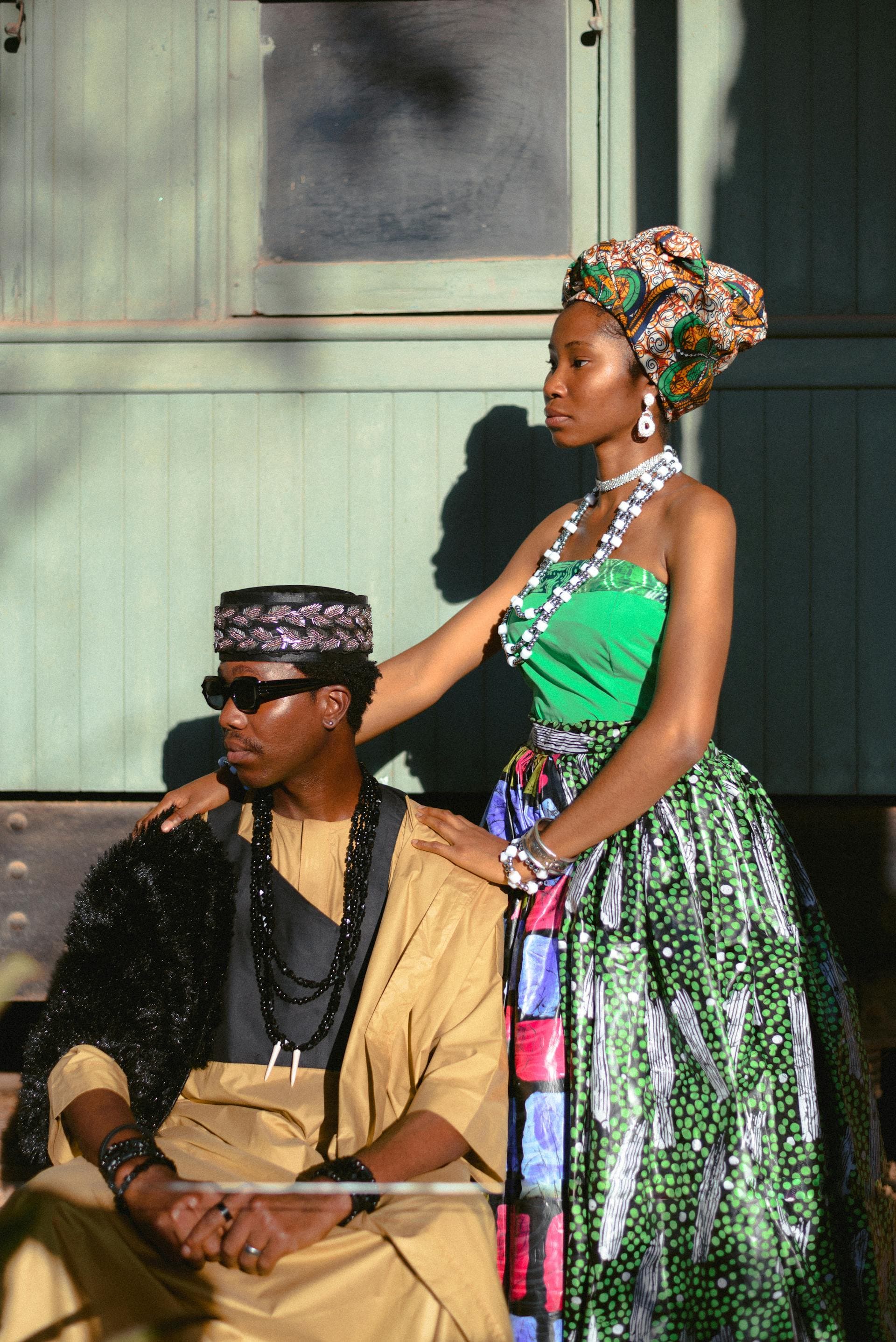 Styled luxury editorial portrait with two models in statement looks