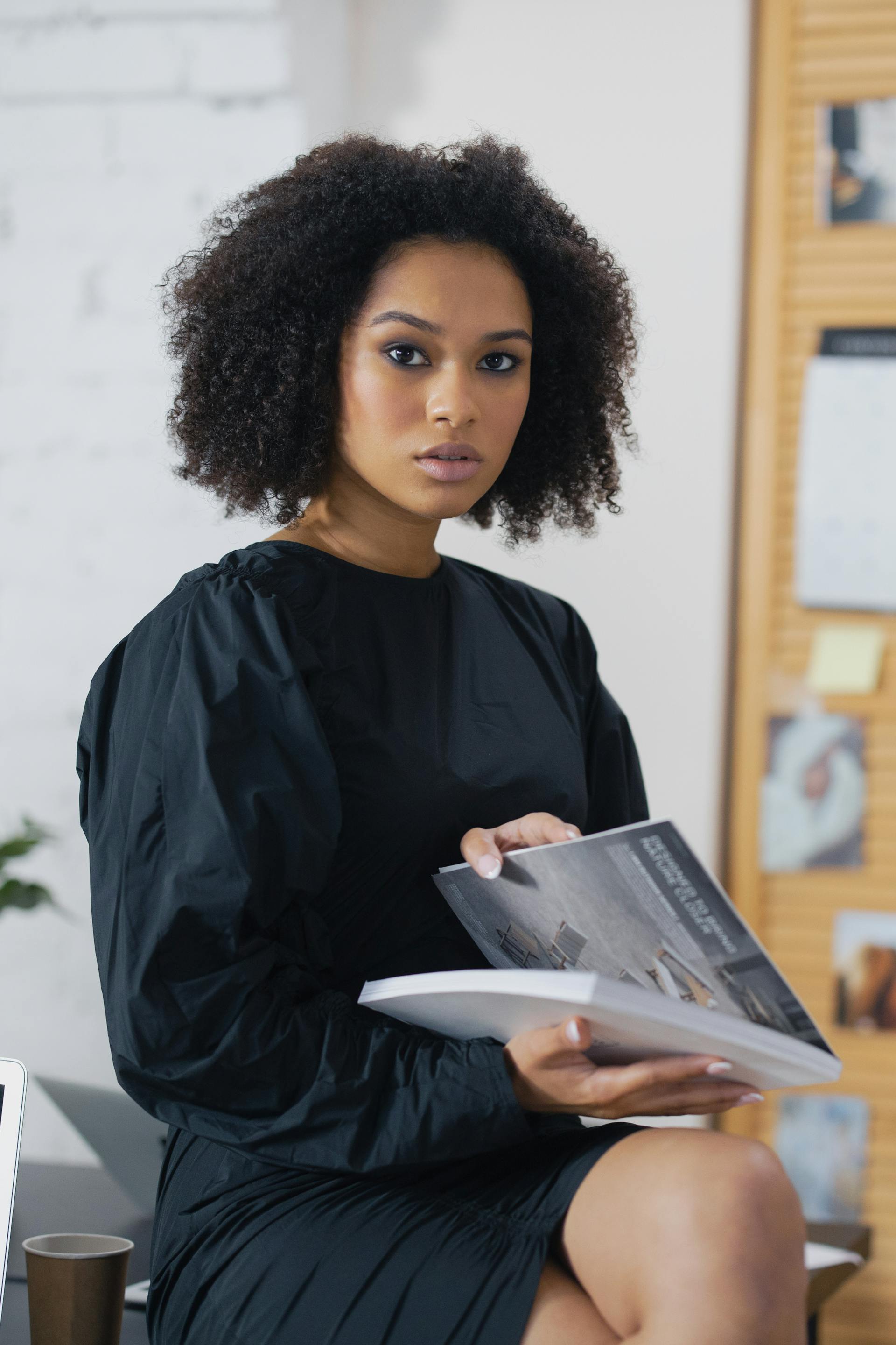 Professional holding an architecture publication in a studio setting