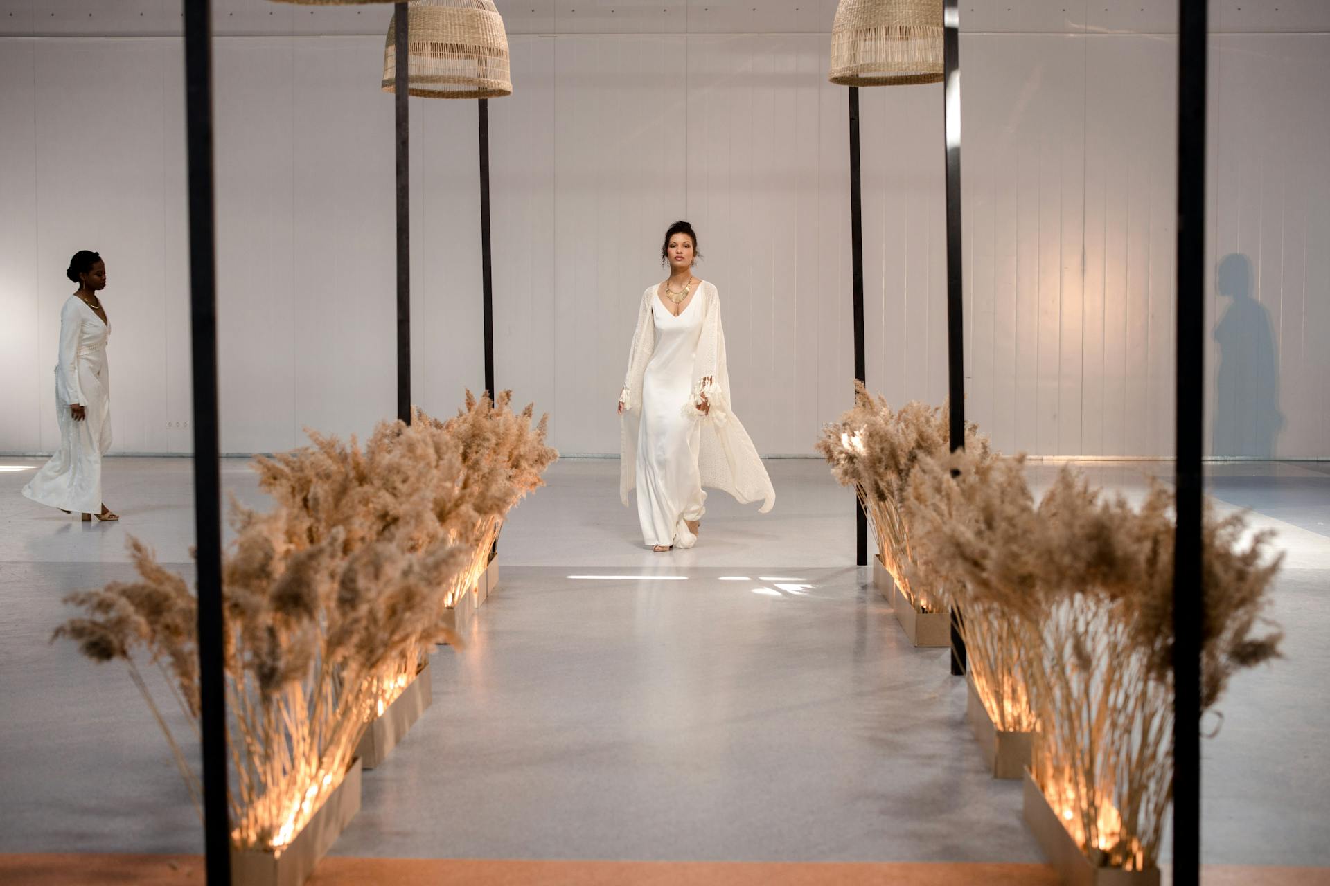 Model walking through a softly lit luxury runway set